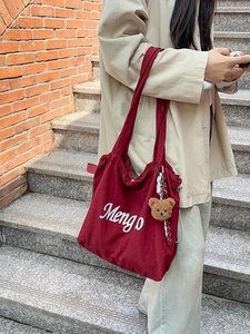 Burgundy tote bag with Mengo embroidery and brown plush bear charm for daily commute