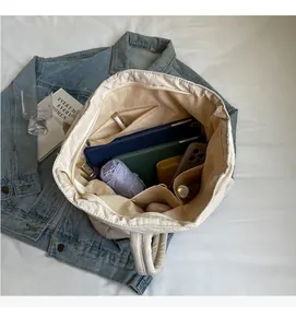 Spacious canvas tote interior with multi-compartment dividers for organized daily storage