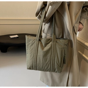Olive green nylon tote bag featuring long reinforced straps and side zipper pocket detail