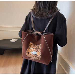 Detail of brown suede multi-way backpack with leopard cat patch and dog embroidery