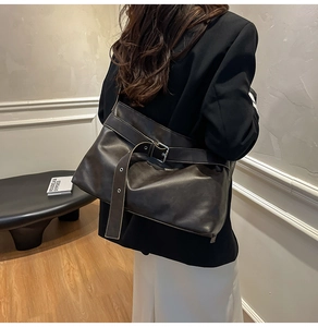Detail view of the vintage soft leather motorcycle bag with buckle strap and large capacity