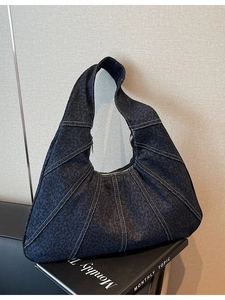 Dark blue leopard print crescent hobo bag with contrast white stitching and denim texture