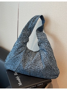 Blue denim leopard print shoulder bag with crescent shape and zipper closure