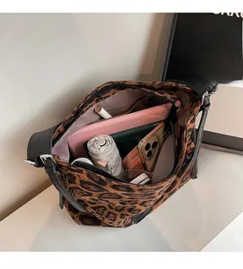 Detail shot of leopard print tote bag interior showing spacious storage for tablet and daily items