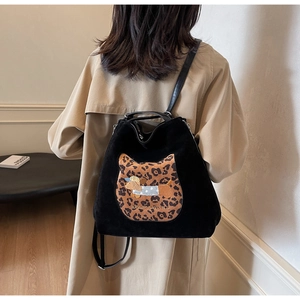 Detail of black suede backpack with leopard cat-ears and puppy embroidery back view