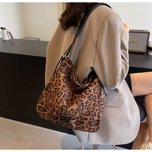 Detailed back view of a large capacity leopard print hobo shoulder bag worn by a model