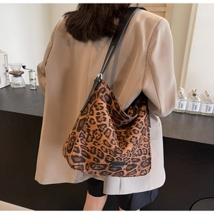 Detailed close-up of a fashionable leopard print hobo bag with adjustable black strap