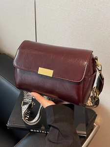 Retro burgundy faux leather crossbody bag with wide woven strap and golden buckle