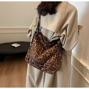 Detailed view of leopard print tote bag styled as a chic shoulder hobo bag on a model