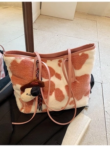 Pink cow print plush tote bag with furry texture and leather straps for winter