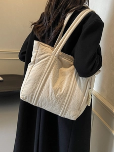 Quilted beige tote bag with large capacity and minimalist design for casual women wear