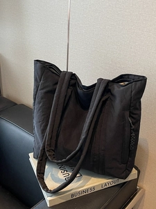 Black quilted tote bag for women with large capacity and side zipper detail for daily use