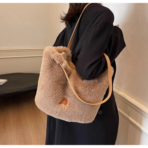 Detailed side view of a fluffy khaki plush tote bag with brown leather shoulder straps
