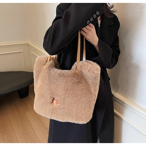 Close-up of fluffy apricot tote bag featuring premium faux fur and brown leather handles
