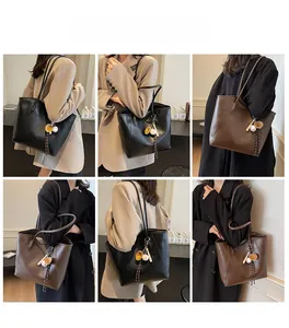 Detailed views of women large tote bag in black and brown with tassel charms for commuting