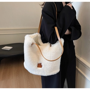 Detail shot of the large white plush tote bag with brown faux leather shoulder strap
