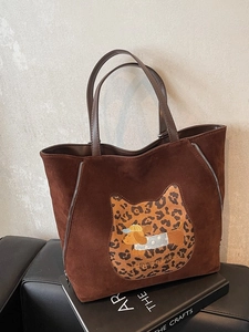 Brown faux suede tote bag featuring leopard cat patch and dachshund embroidery on books