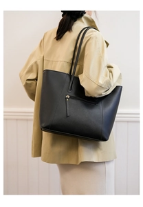 Rear view of a black leather tote bag featuring a practical functional zipper pocket