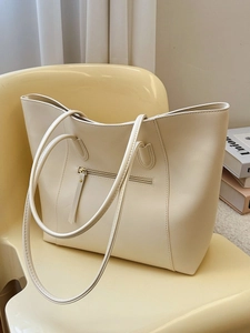 Minimalist off-white leather tote bag with large capacity and exterior zipper detail