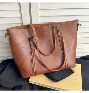 Détail du sac fourre-tout vintage en cuir PU marron avec de longues anses et fermeture éclair