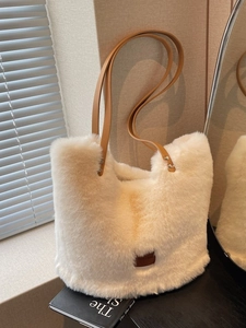Cream plush tote bag with brown leather straps and soft faux rabbit fur for winter