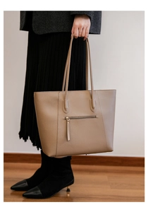 Macro view of khaki tote bag with a functional back zipper pocket and premium faux leather