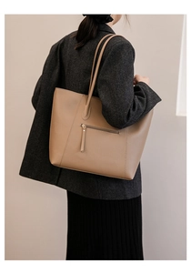 Detail of dark khaki leather tote bag featuring a practical back zipper pocket for women