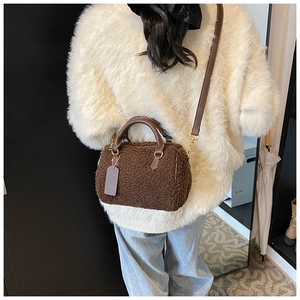 Detailed back view of a plush brown faux fur Boston bag with leather straps and gold hardware