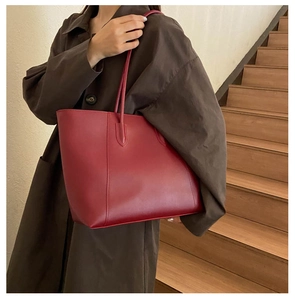 Close-up of deep red tote bag made of high-quality faux leather for daily commuting use