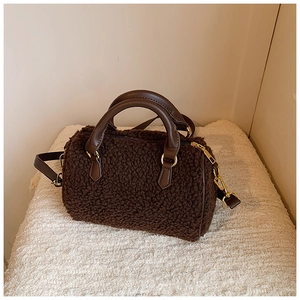 Detail of plush brown Boston bag showing lamb wool texture and faux leather straps