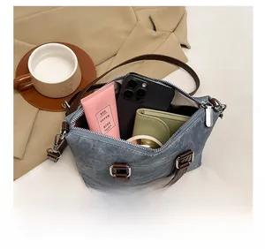 Spacious interior of denim bucket bag showing phone and wallet storage capacity