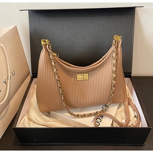 Detailed shot of pleated khaki hobo bag with gold chain and hardware in a premium gift box