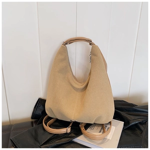 Detail of khaki hobo tote bag in suede texture with brown shoulder straps and chic design
