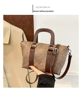 Detailed close-up of brown vintage bucket bag texture with durable dark handles