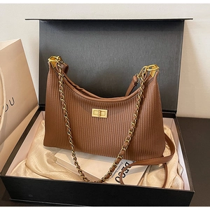Brown pleated underarm bag with gold chain strap in a premium gift box set
