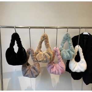 Detailed display of six faux mink fur cloud bags in various colors hanging on a rack