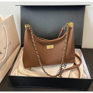 Brown pleated leather underarm bag with gold chain strap in premium gift packaging box
