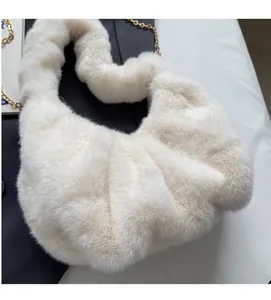 Close-up of plush cloud bag with soft faux fur texture and golden chain strap