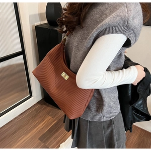 Caramel brown pleated hobo bag featuring a gold rectangular twist lock and smooth texture