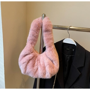 Close-up of pink faux fur texture and metal chain strap on a plush crossbody bag