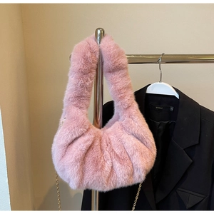 Detailed view of pink faux fur hobo bag with a delicate gold chain strap for women