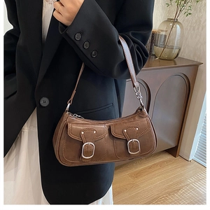 Close-up of a brown PU leather shoulder bag with dual pockets and silver metal buckles