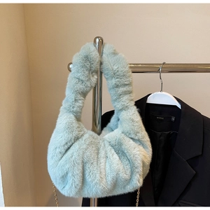 Detailed view of light green faux fur cloud bag featuring fluffy pleats and gold chain