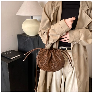 Detail der Leoparden-Beuteltasche mit Kordelzug und schmalem Griff am Modell