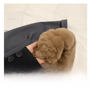 Detail of soft brown faux fur handle on a stylish winter plush bag being held
