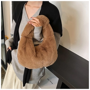 Close-up of brown plush dumpling handbag with soft faux rabbit fur texture
