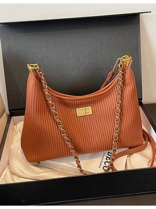 Brown pleated shoulder bag with gold chain strap and metal clasp in a gift box