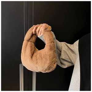 Detailed view of plush brown faux fur texture on a stylish autumn-winter handbag