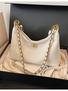 White pleated underarm bucket bag with gold chain strap in a premium gift box set