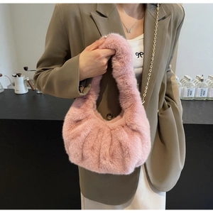 Close-up of pink faux fur crossbody bag with soft texture and ruched plush handle detail
